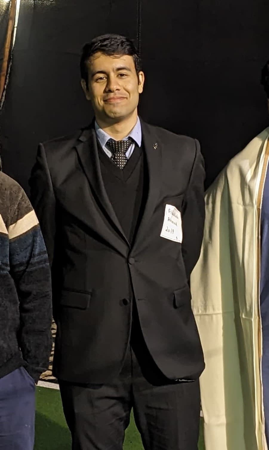 Full-body portrait of Abdullah Ahmad in a suit, presenting a professional appearance suitable for a portfolio or business profile.